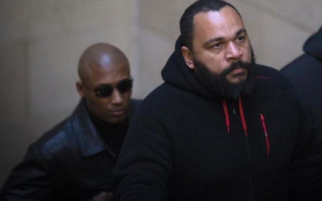 Dieudonné M'Bala M'Bala à son arrivée au tribunal de Paris, le 13 décembre 2013. (Crédit : Joel Saget/AFP)